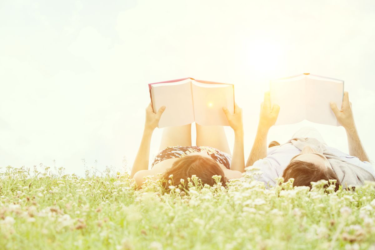 Couple,Reading,Book,In,The,Park,Together