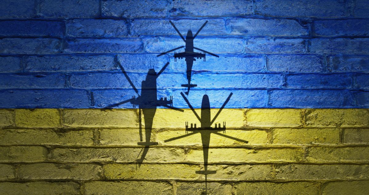 Flag,Of,Ukraine,Painted,On,A,Concrete,Wall,With,Russian