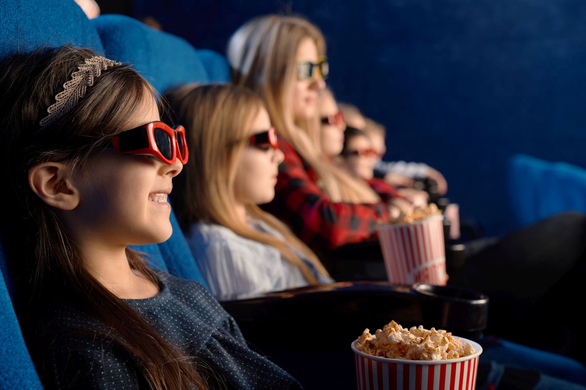Little friends wearing 3d eyeglasses in cinema.