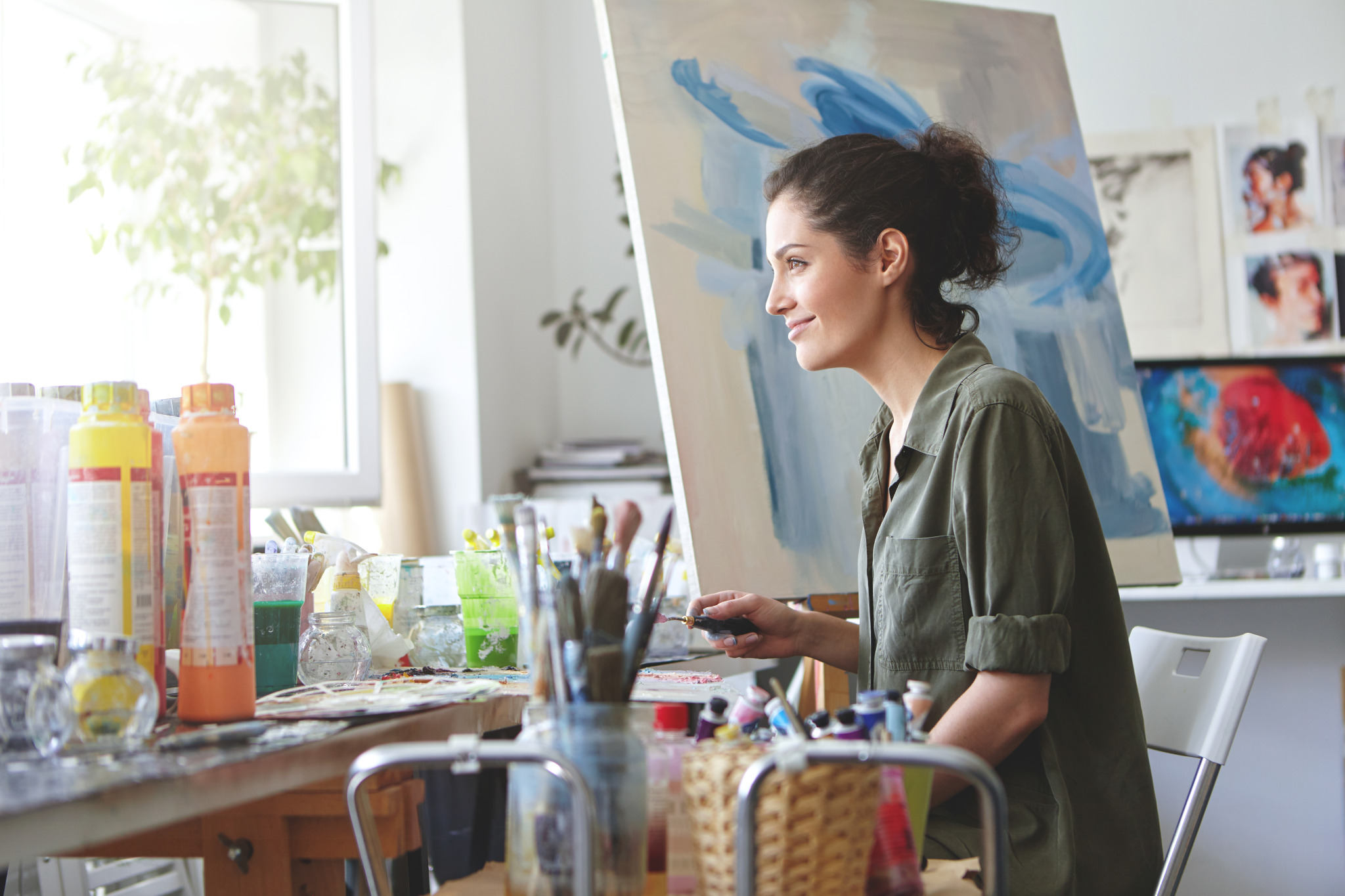 delightful-female-dressed-casually-looking-window-enjoying-sunshine-while-working-her-workshop-creating-beautiful-picture-painting-with-colorful-oils-woman-painter-drawing-canvas